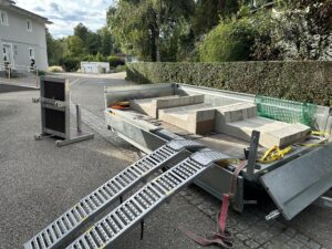Concrete PV mounting ballast elements loaded on trailer for transport
