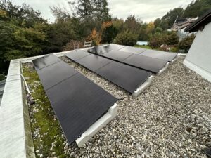 Solar panels mounted on concrete supports on garage flat roof