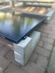 Detail of solar panel clamp fixed to concrete photovoltaic support