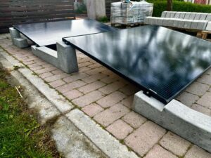 Installed concrete solar mounting system for flat roof photovoltaic panels