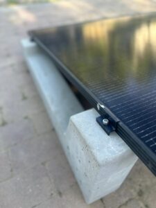 Close-up of solar panel mounted on concrete ballast support system