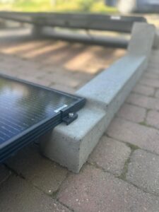 Flat roof solar mounting structure with concrete ballast support
