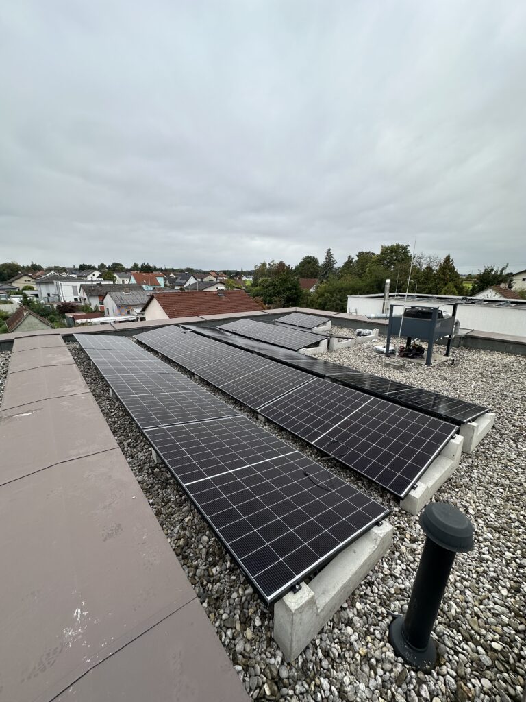 Concrete ballast blocks installed on a flat roof solar project near Linz, Austria